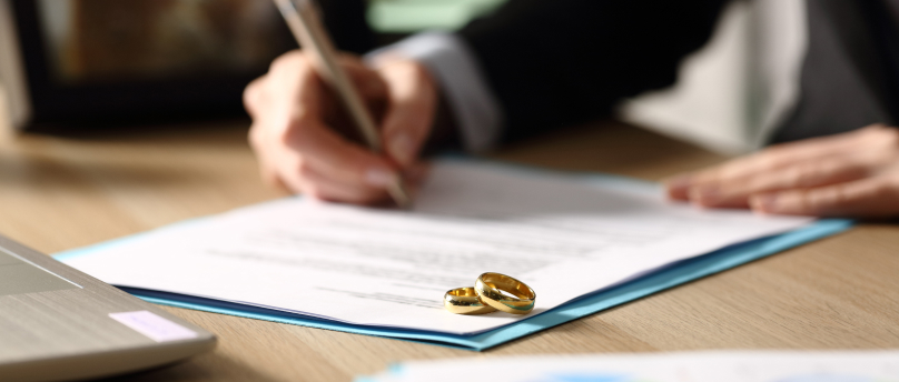 divorce lawyer with wedding rings on document